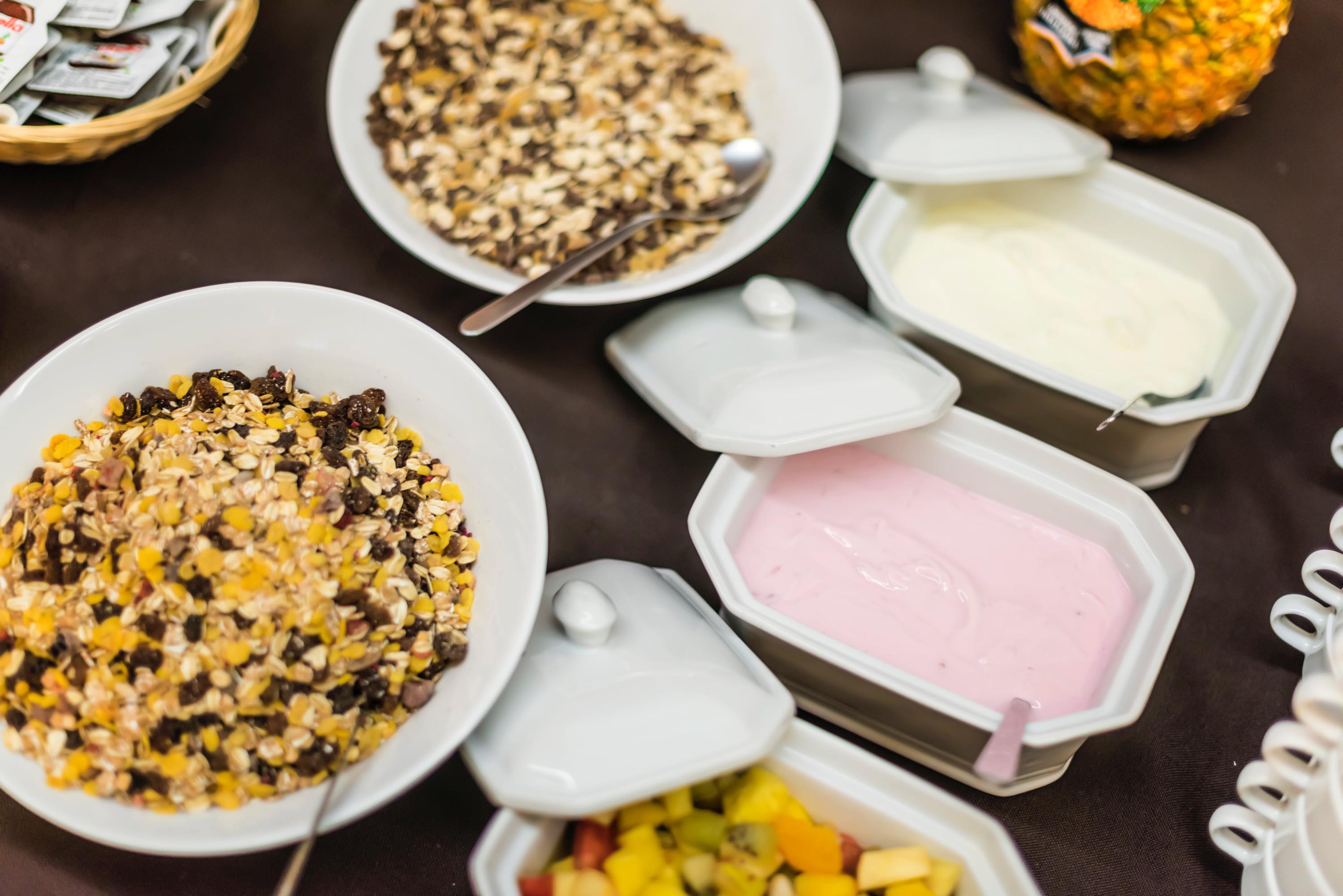 Bowls with yogurt, fruit salad, and granola