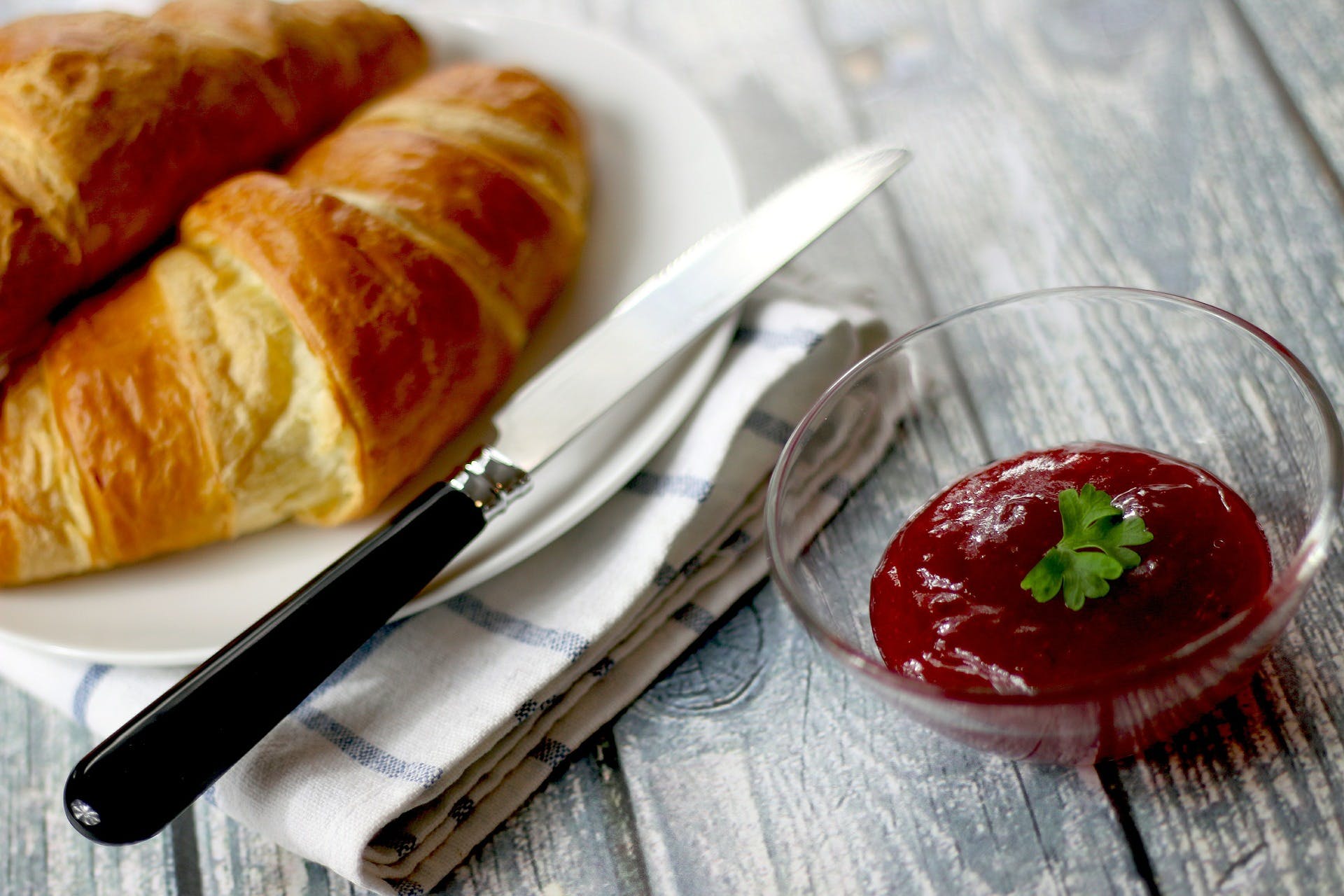 Croissants on a plate next to a dip