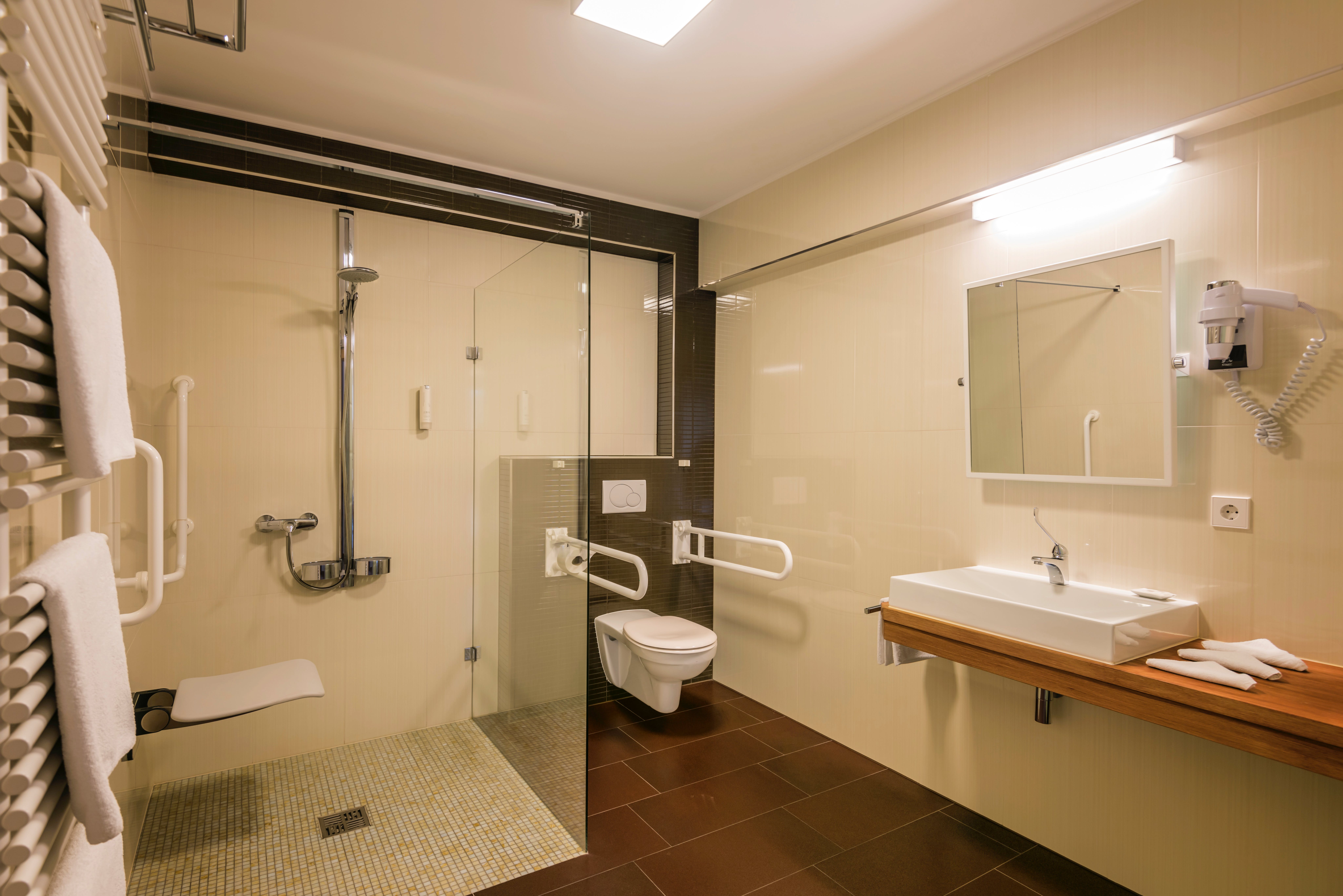 Bathroom with shower, mirror, and toilet